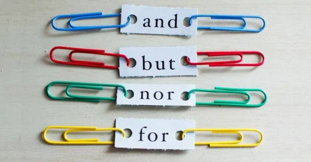 Four paper clips arranged horizontally with words printed on torn paper: 'and', 'but', 'nor', and 'for'. Each word is attached to a differently colored paper clip.